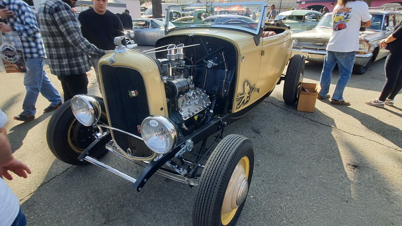 Kremowy Ford roadster z 1932 roku – highboy z odsłoniętym silnikiem i pinstripem