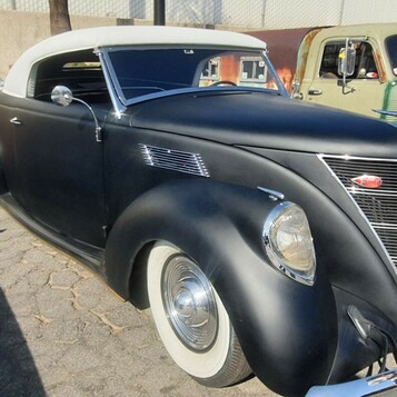 Matowy czarny Ford kabriolet z 1937 roku – biały dach i chromowana atrapa w kształcie serca