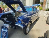 Granatowy Chevrolet z 1957 roku jako gasser – wtrysk Hilborn z chromowanymi lejkami pod otwartą maską – zdjęcie 1