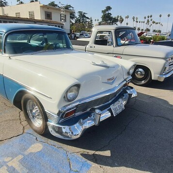 Biało-turkusowy Chevrolet 210 z 1956 roku – dwudrzwiowy sedan na białych ściankach