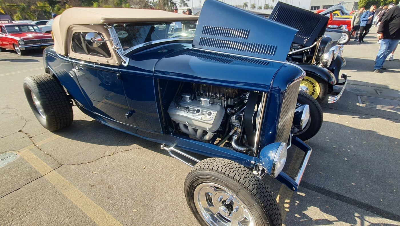 Granatowy Ford roadster z 1932 roku z beżowym dachem i otwartą maską – Deuce highboy z żaluzjami