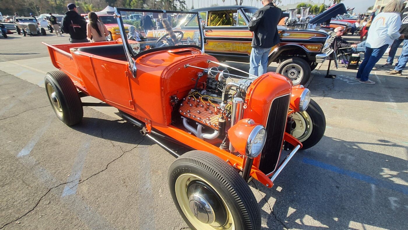 Pomarańczowy Ford Model T roadster pickup z 1927 roku – hot rod z silnikiem na wierzchu na kremowych felgach