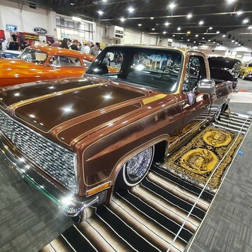 Brązowo-złoty Chevrolet C10 square body lowrider – panele, koronka i druciane felgi na pickupie z lat 70.